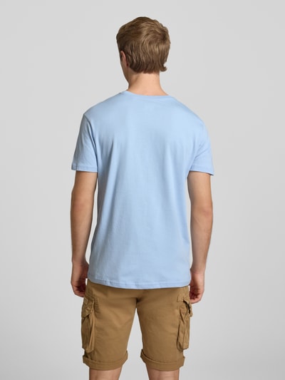 Männermodel trägt T-Shirt mit Logo und Rundhalsausschnitt von Alpha Industries aus Reine Baumwolle, Regular-Fit, Rückenlänge 67 cm, Ganzkörperansicht Rückansicht.