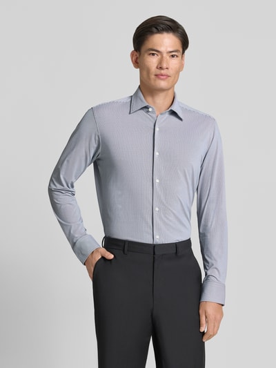 Männermodel trägt Regular Fit Businesshemd mit Strukturmuster Modell 'P-JOE-K-261' von BOSS, dezente Grau- und Schwarztöne, Ganzkörperansicht von vorne. Herren Businesshemd von BOSS.