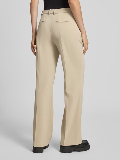 Frauenmodel trägt Hose mit Bügelfalten Modell 'ARGUE' von Drykorn in Beige, Regular Fit, glatte Struktur, Ganzkörperansicht Rückansicht. Damen Hose, Material-Mix mit Stretch-Anteil, Bundweite bei Größe 27/34: 40 cm, Innenbeinlänge: 82 cm.