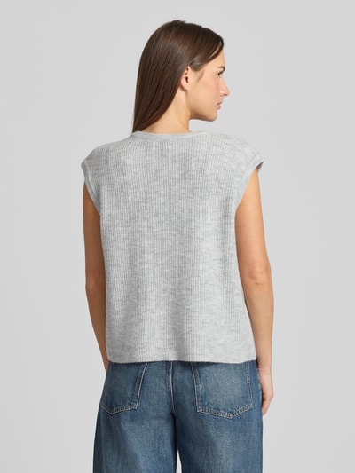 Frauenmodel trägt Loose Fit Strickweste mit Knopfleiste Modell 'Everest' von Neo Noir in Hellgrau, feine Rippenstruktur, Ganzkörperansicht Rückansicht.