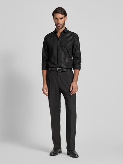 Männermodel trägt Slim Fit Business-Hemd mit Kentkragen von Jake*s, gestreift, Baumwoll-Mix, schwarze Töne, Ganzkörperansicht von vorne. Rückenlänge bei Größe 39/40: 78 cm, Schulterbreite: 46 cm, Ärmellänge: 66 cm.