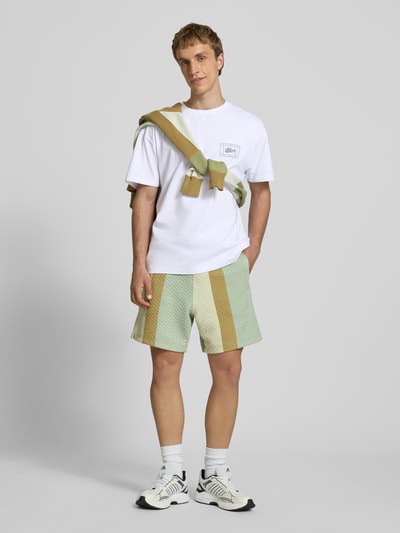 Mannelijk model draagt Regular Fit T-Shirt met Logo-Print van BLKVIS, wit katoen, ronde hals, maat M ruglengte 67 cm, vooraanzicht hele lichaam.