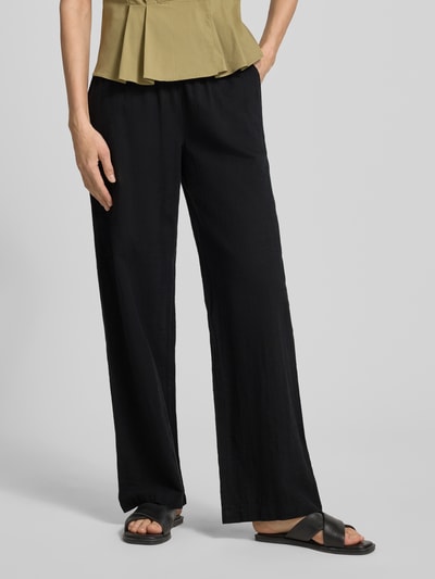 Frauenmodel trägt Weite HOSE aus Baumwoll-Leinen-Mix Modell 'CAIA' von Vero Moda, Optik: Unifarben, Passform: Wide Leg, Verschluss: Tunnelzug, Bundabschluss: Elastisch, seitliche Eingrifftaschen, glatte Textur, schwarze Farbe, Ganzkörperansicht von vorne.
