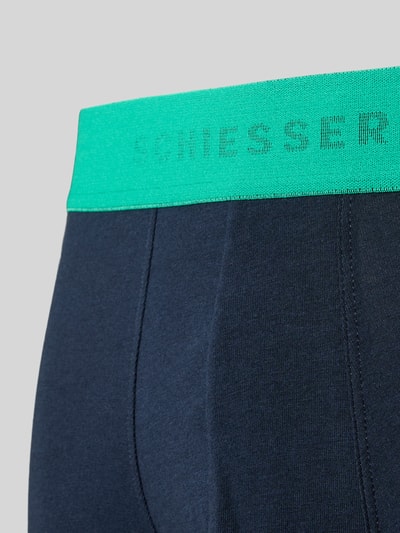 Produktfoto, dunkelblaue Slim Fit Trunks aus Baumwoll-Mix von SCHIESSER mit elastischem grünen Bund und Logo-Detail, feine glatte Textur