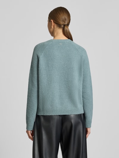 Frauenmodel trägt Regular Fit Strickpullover aus Alpaka-Mix mit Baumwoll-Anteil Modell 'FEBISAN' von BOSS in Hellblau, Ganzkörperansicht Rückansicht. Unifarbene Optik, Rundhalsausschnitt, lange Ärmel, gerippte Abschlüsse, weiche Stricktextur.