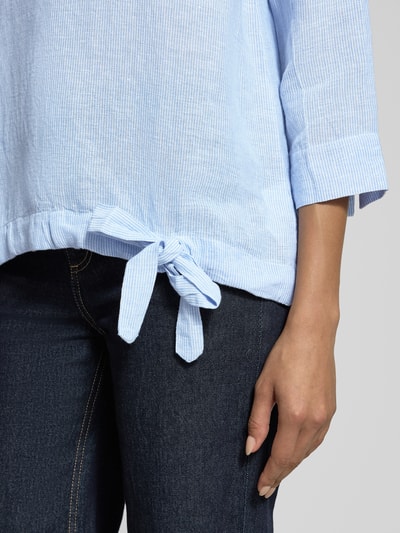 Vrouwenmodel draagt Relaxed Fit Bluse aus Leinen-Mix van Christian Berg Woman, lichtblauw-witte tinten, linnen-katoenmengsel, detailopname.