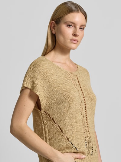 Modelka kobieca ma na sobie Strickshirt mit Kappärmeln Modell 'CARYNN' od Soyaconcept, krój relaxed fit, okrągły dekolt, krótkie rękawy, długość tyłu w rozmiarze S/M: 58 cm, długość rękawów w rozmiarze S/M: 15 cm, beżowy melanż z widoczną strukturą dzianiny, detaliczne ażurowe wzory, półzbliżenie od przodu.