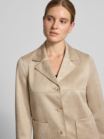 Frauenmodel trägt Regular Fit Blazer in Leder-Optik mit aufgesetzten Taschen von COMMA, beige Farbton, glatte Textur, Nahaufnahme Oberkörper.