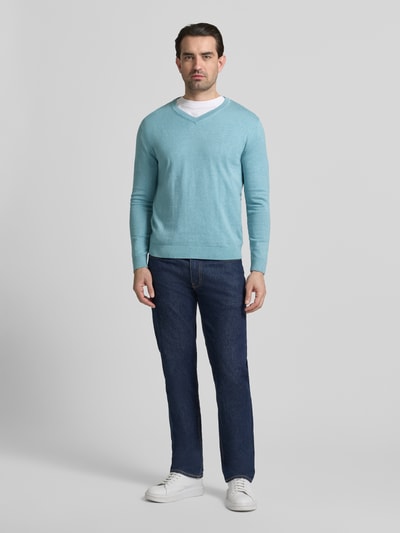 Mannelijk model draagt Regular Fit Pullover aus reiner Baumwolle van Tom Tailor in lichtblauw, fijne katoenen brei, basic stijl, unicolor, logo-stiksel, lange mouw met geribde boorden, V-hals, regular fit, voorkant volledige lichaamsopname.