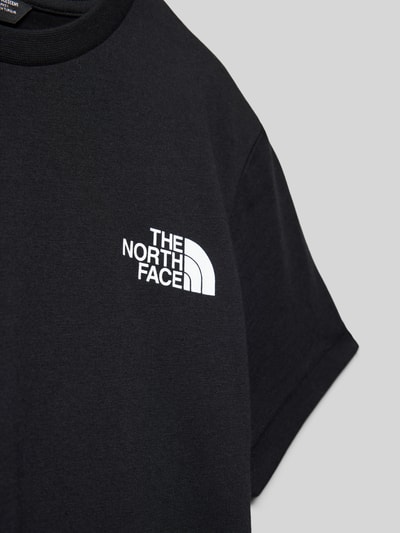 Produktfoto, Regular Fit T-Shirt mit Logo-Print von The North Face, Kinder T-Shirt in Schwarz, weißer Logo-Print, Rundhalsausschnitt, Statement-Print, Rückenlänge bei Größe M 51 cm