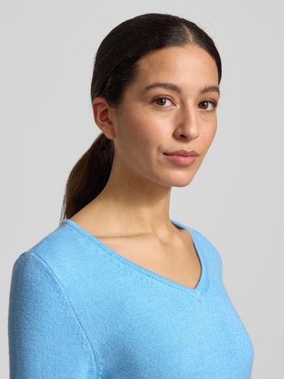 Frauenmodel trägt Regular Fit Longsleeve aus Viskose in Strick-Optik Modell 'Viril' von Vila, hellblau, V-Ausschnitt, Nahaufnahme Oberkörper.