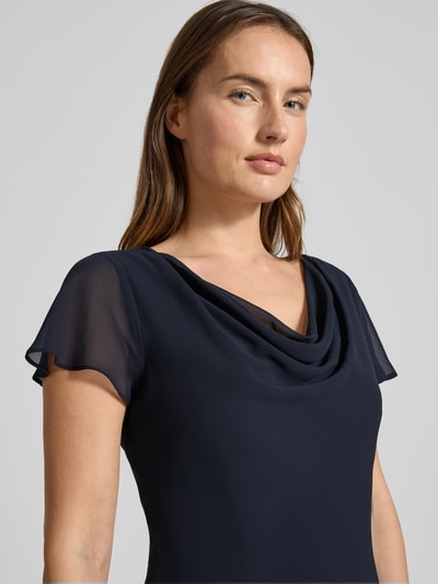 Männermodel trägt Tailliertes Cocktailkleid mit Volants von Christian Berg Cocktail, granatowy kolor, marszczenia, gładka tekstura, Nahaufnahme Oberkörper.