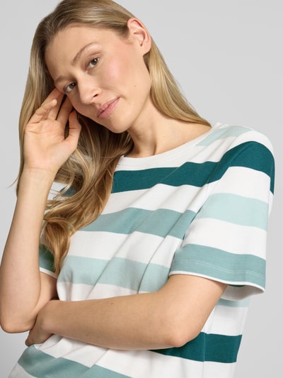 Vrouwenmodel draagt Relaxed Fit T-Shirt aus reiner Baumwolle van Tom Tailor, gestreept design, korte mouwen, ronde hals, katoen, detailopname bovenlichaam.