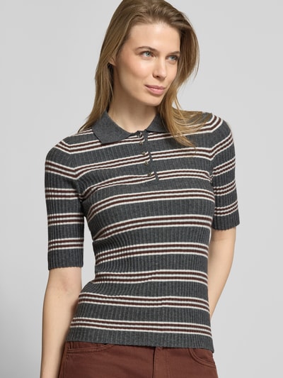 Frauenmodel trägt Strickshirt aus Viskose-Mix mit Polokragen Modell 'HIJAS' von Mango, Ripp-Optik, Slim Fit, Nahaufnahme Oberkörper.