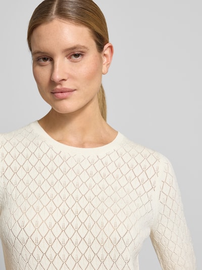Vrouwenmodel draagt Regular Fit T-Shirt in Ausbrenner-Optik Modell 'HELEN' van Selected Femme in effen beige, fijngebreide viscosemix, unicolour structuur, ronde hals, 1/2-mouw met geribde boorden, detailopname bovenlichaam.