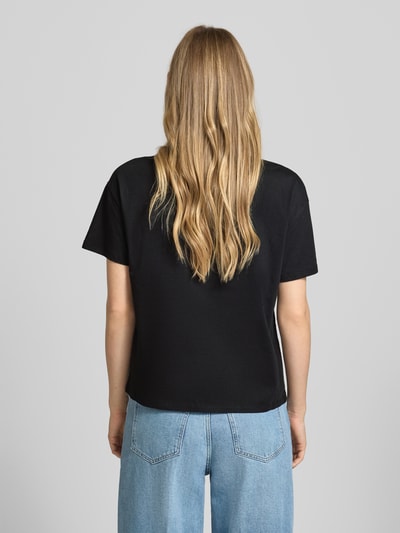 Frauenmodel trägt T-Shirt mit Label-Stitching und Ziersteinbesatz von Liu Jo White aus bawełna, krój regular fit, okrągły dekolt, damski t-shirt, długość tyłu w rozmiarze S: 56 cm, kolor czarny, fason prosty, gładka faktura, Ganzkörperansicht Rückansicht.
