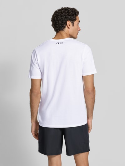 Männermodel trägt weißes Regular Fit Sport-T-Shirt aus Baumwoll-Mix von Under Armour, schwarze Shorts, Ganzkörperansicht Rückansicht, Herren Sport-T-Shirt von Under Armour.