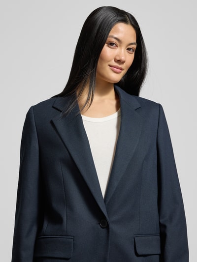 Vrouwenmodel draagt donkerblauwe Relaxed fit blazer met klepzakken Model 'GLENDALE' van Drykorn, materiaalmix met viscose, reverskraag, knoopsluiting, borstwijdte 33 cm, mouwlengte 60 cm, ruglengte 72 cm, nahaufnahme bovenlichaam.