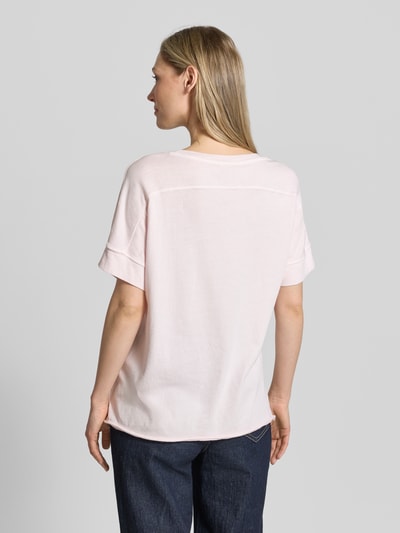 Modelka kobieca nosi Relaxed Fit T-Shirt aus reiner Baumwolle od s.Oliver RED LABEL, jasnoróżowy, gładki, bawełna, krótki rękaw, luźny krój, detal z logo, widok całej sylwetki z tyłu.