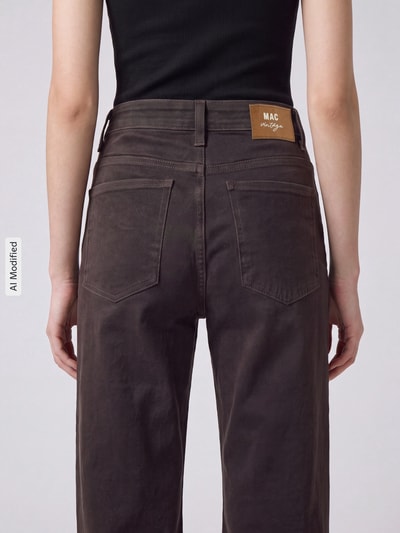 Frauenmodel trägt Barrel Jeans aus Baumwoll-Mix Modell 'OHIO' von MAC in Dunkelbraun, sichtbare Nähte, Damen Barrel Jeans von MAC, Ganzkörperansicht Rückansicht, KI-modifiziertes Bild.
