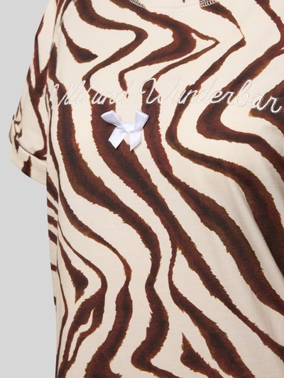 Vrouwenmodel draagt Nachthemd aus reiner Baumwolle Modell 'Wild und Wunderbar' van LOUIS & LOUISA, bruin-wit zebrapatroon, ronde hals, met korte mouwen, statement-stitching en sierstrik, detailopname bovenlichaam.