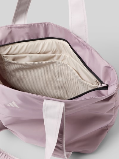Produktfoto, Tote Bag mit Logo-Print Modell 'Yoga' van adidas Sportswear in lichtpaars met roomwit, hoofdvak met rits, schouderriem, context: dames Tote Bag, breedte 42 cm, lengte 33 cm, diepte 20 cm, schouderriem 67 cm