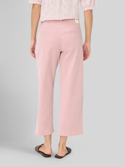 Frauenmodel trägt Wide Leg Jeans aus Lyocell-Mix Modell 'STYLE.MAINE S' von Brax in Optik: Unifarben, Cropped-Länge, Label-Patch, seitliche Eingrifftaschen, Leistengesäßtaschen, Knopf und verdeckter Reißverschluss, sanfte rosa Farbe, glatte Struktur, Ganzkörperansicht Rückansicht.