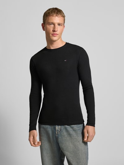 Mannelijk model draagt Slim Fit Longsleeve met ribstructuur van Tommy Jeans, puur katoen, ronde hals, geborduurd logo op borst, Ganzkörperansicht von vorne.