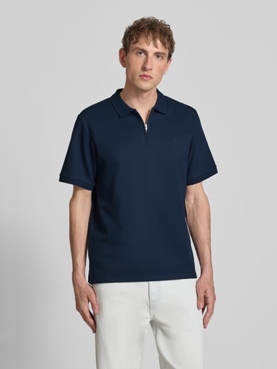 Mannenmodel draagt Regular Fit poloshirt met ritssluiting model 'AUSTIN' van Jack & Jones, materiaalmix met katoen, structuurpatroon, ruglengte bij maat M 69 cm, donkerblauw, voorkant volledige lichaamsopname.