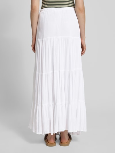 Vrouwenmodel draagt Maxirock im Stufen-Look van REVIEW, witte A-lijn rok van viscose met tunnelkoord en stapeleffect, volledige lichaamsweergave achteraan.