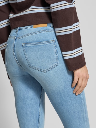 Frauenmodel trägt Flared Fit Jeans im 5-Pocket-Design von Review aus elastischem Baumwoll-Mix in hellem Blau, Detailaufnahme Rückansicht.