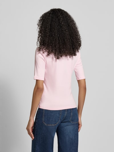Kobiece modelka nosi T-shirt mit V-Ausschnitt von Christian Berg Woman, mieszanka bawełny i elastanu, krój regular fit, rękaw o dł. 1/2, długość tyłu w rozmiarze S: 55 cm, różowy, gładka faktura, widok całej sylwetki z tyłu.