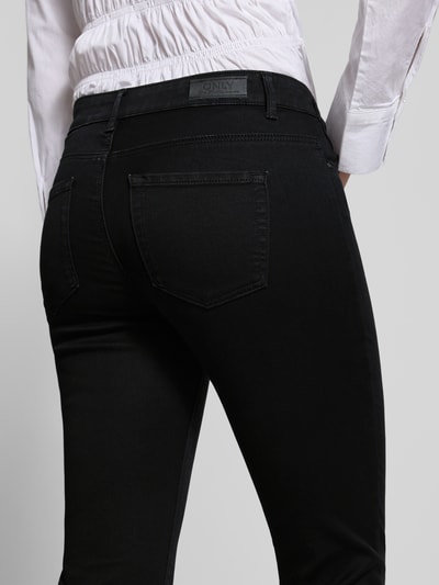 Vrouwenmodel draagt Regular Waist Bootcut-Jeans met Retro-Flare van ONLY, effen kleuren denimlook, 5-pocketmodel, dark wash, detailopname rugaanzicht.