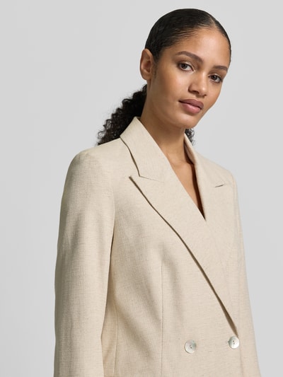 Kobiece model prezentuje Regular Fit Blazer aus Baumwoll-Leinen-Mischung mit doppelter Knopfleiste von Jake*s Collection, beżowa kolorystyka, faktura lnu, kołnierz z klapami, kieszenie z patkami, szerokość w rozmiarze 36: 46 cm, długość tyłu: 71 cm, długość rękawa: 65 cm, zbliżenie na górną część ciała