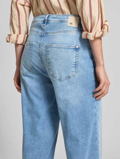 Kobieta modelka nosi Wide Leg Jeans in verkürzter Passform Modell 'SVENTY 7/8' od Raffaello Rossi, bawełniany mix z lyocellem, używany wygląd, jasnoniebieski kolor, Szerokość w rozmiarze 36: 39 cm, długość wewnętrzna nogawki: 70 cm, całkowity widok z tyłu.