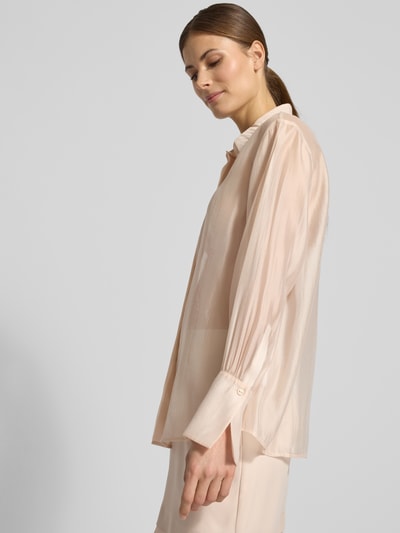 Modelka nosi Organza-Bluse mit großen Manschetten - curated by Vicky Heiler od Damen Hemdbluse SIC curated by vickyheiler, półprzezroczysty materiał, krój regular fit, klasyczny kołnierzyk, długi rękaw z wykończonym mankietem, zapięcie na guziki, kremowy kolor, lekka tekstura, długość tyłu 66 cm, długość rękawa 58 cm, widok całej sylwetki z przodu
