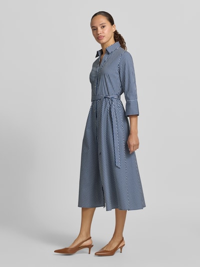 Frauenmodel trägt Hemdblusenkleid mit Bindegürtel und Knopfleiste von Zero, blau-weiß gestreift, taillierter Schnitt, Ganzkörperansicht von vorne.