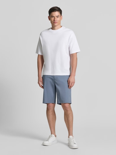 Männermodel trägt Bermudas aus Light Baumwolle mit Gürtel von Christian Berg Men in Blau, Regular Fit, Eingrifftaschen, Ganzkörperansicht von vorne.