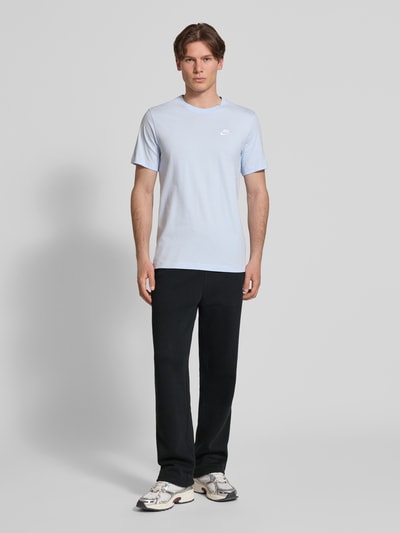 Männermodel trägt Sweatpants mit Logo-Stitching und Eingrifftaschen von Nike aus Baumwoll-Mix, Loose-Fit, Schwarz, Ganzkörperansicht von vorne.