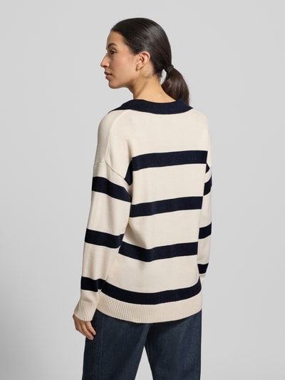 Frauenmodel trägt Strickpullover mit V-Ausschnitt Modell 'KANITA' von Soyaconcept, beige mit dunkelblauen Streifen, locker geschnitten, Rückenansicht.