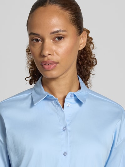 Kobiece modelka nosi Regular Fit Hemdbluse aus Baumwoll-Mix od Smith and Soul, mieszanka bawełny, krój regular fit, nakładane kieszenie, kołnierzyk koszulowy, długi rękaw, długość tyłu w rozmiarze S: 54 cm, długość rękawów w rozmiarze S: 55 cm, jasnoniebieski kolor, gładka tekstura, prosty design, zbliżenie na górną część ciała.