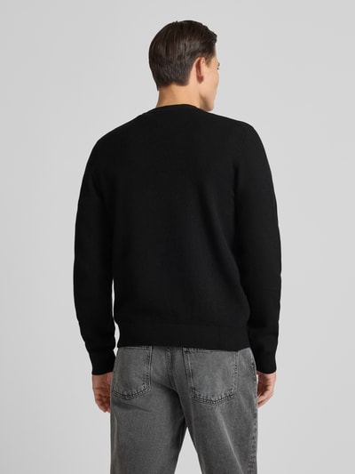 Męski model nosi Regular Fit Strickpullover mit Schurwoll-Anteil Modell 'SETAL' od HUGO, czarny, dzianina, widok całej sylwetki z tyłu.