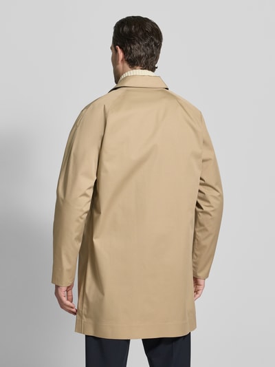 Männermodel trägt Regular Fit Regenjacke mit Baumwoll-Anteil Modell 'ROKIG' von Barbour, unifarben beige, glatte Struktur, Ganzkörperansicht Rückansicht.