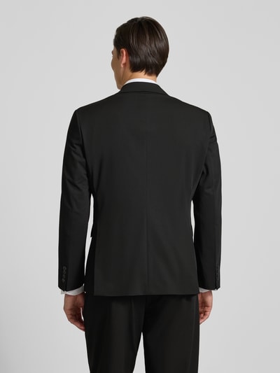 Männermodel trägt Regular Fit Anzugsakko mit Viskose-Anteil Modell 'LIAM' von SELECTED HOMME, unifarben, Rückenschlitz, Ganzkörperansicht Rückansicht.