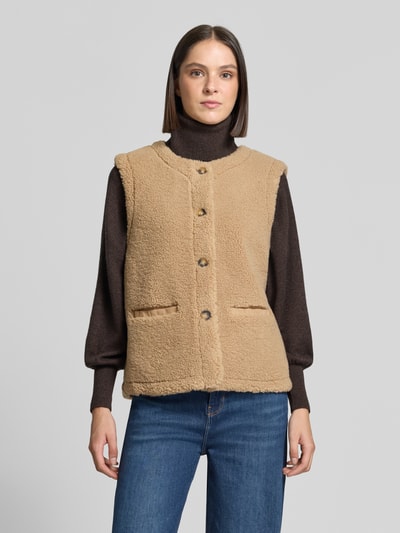 Vrouwenmodel draagt bodywarmer van teddybont Model 'Eddy' van FREE/QUENT, regular fit, paspelzakken, ruglengte maat S 58 cm, schouderbreedte 38 cm, borstwijdte 51 cm, kleur beige, textuur zacht, voorkant volledig zichtbaar, Ganzkörperansicht von vorne.