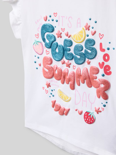 Produktfoto, Regular Fit T-Shirt mit Statement-Print von Guess für kinder mit buntem Motiv-Print, Rüschenbesatz und Logo-Print auf Baumwoll-Mix