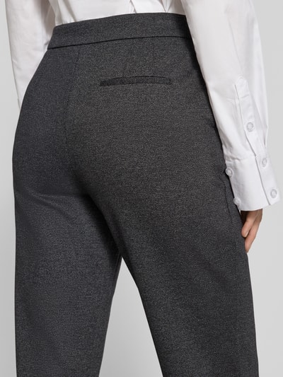 Frauenmodel trägt Hose aus Viskose-Mix Modell 'CHARLIE' von GUIDO MARIA KRETSCHMER WOMAN, dunkle Farbe, Paspeltasche, Nahaufnahme Rückansicht.