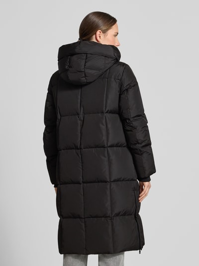 Frauenmodel trägt Regular Fit Mantel in Stepp-Optik Modell 'Nova' von MOS MOSH in Schwarz, Zweiwege-Reißverschluss, Rückenansicht, Ganzkörperansicht Rückansicht, Kontext: Damen Mantel mit Kapuze, Tunnelzug, Eingrifftaschen, Länge 102 cm, Schulterbreite 42 cm, Brustweite 46 cm, Ärmellänge 64 cm.