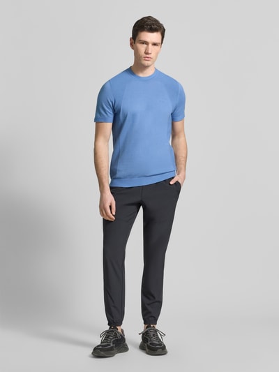 Männermodel trägt Regular Fit T-Shirt aus Baumwoll-Mix Modell 'MOMENTUM-LITE' von BOSS Green, Optik: Unifarben, Label-Print, Ganzkörperansicht von vorne.