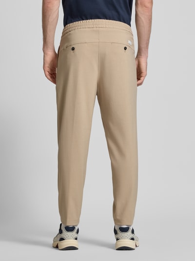 Männermodel trägt Spodnie z zakładkami w pasie Relaxed Fit z dodatkiem wiskozy Model 'VIGGO CROPPED' von Marc O'Polo Denim, efekt: jednolity kolor, krój relaxed fit, średni stan, długość krótka, wyhaftowane logo, zakładka w pasie, tunel, elastyczny ściągacz, wpuszczane kieszenie, kieszenie z tyłu, mieszanka materiałów z dodatkiem wiskozy, całkowity widok od tyłu